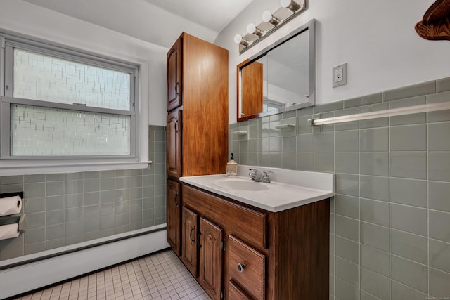 112 Shadow Ln, West Hartford, CT 06110 - bathroom with a baseboard heating unit, tile walls, vanity, and tile patterned floors