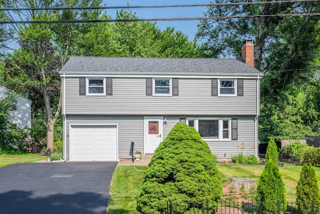 112 Shadow Ln, West Hartford, CT 06110 - colonial house featuring an attached garage, a chimney, and driveway