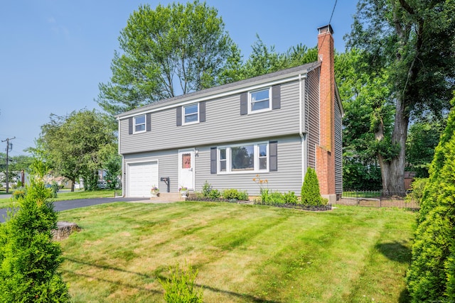 112 Shadow Ln, West Hartford, CT 06110 - colonial-style house with a chimney, asphalt driveway, and a garage