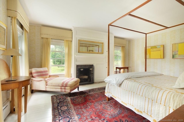 12 Popple Swamp Rd, Cornwall, CT 06754 - bedroom with wallpapered walls, multiple windows, a large fireplace, light wood-style flooring, and crown molding