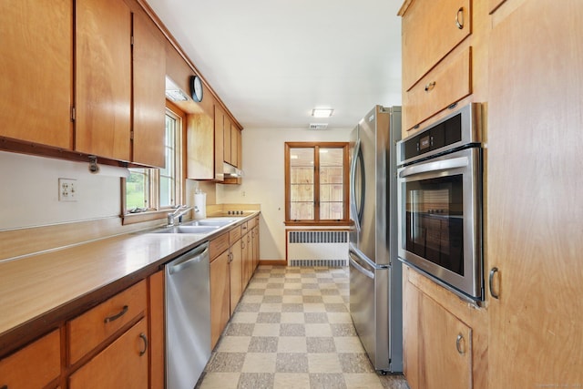 1 Old Middle Rd, New Milford, CT 06776 - kitchen with radiator heating unit, appliances with stainless steel finishes, light flooring, and under cabinet range hood