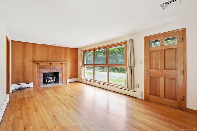 1 Old Middle Rd, New Milford, CT 06776 - unfurnished living room featuring baseboard heating, light wood-style floors, a fireplace, and a baseboard radiator