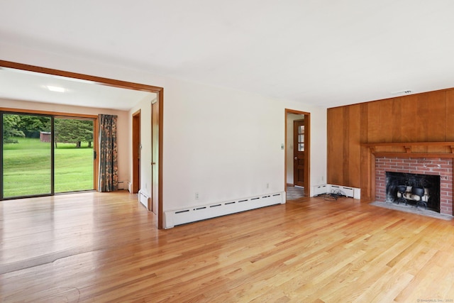 1 Old Middle Rd, New Milford, CT 06776 - unfurnished living room with a baseboard radiator, light wood-style flooring, a brick fireplace, and wooden walls