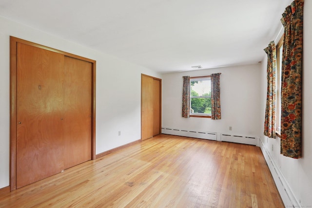 1 Old Middle Rd, New Milford, CT 06776 - unfurnished bedroom with a baseboard radiator, multiple closets, light wood-type flooring, and baseboard heating
