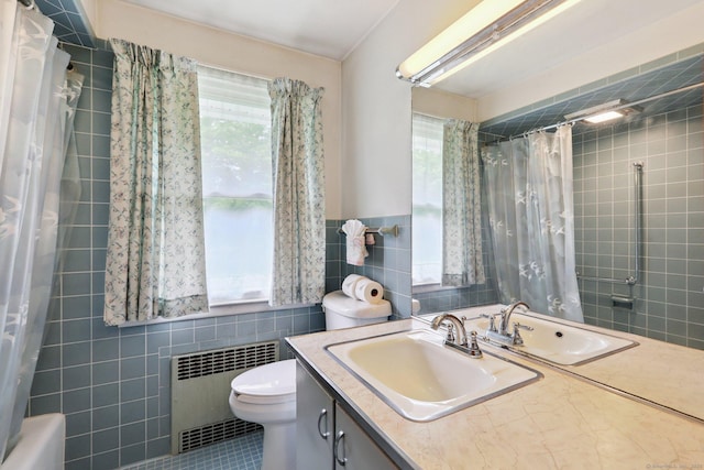 1 Old Middle Rd, New Milford, CT 06776 - bathroom with tile walls, radiator heating unit, vanity, tile patterned flooring, and shower / bath combination with curtain