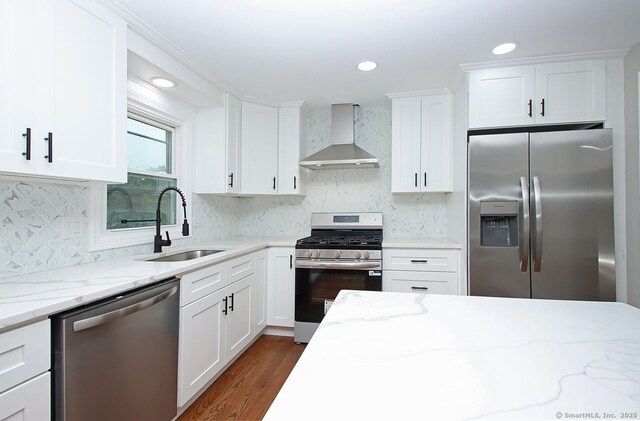 5 Great Meadow Dr, North Haven, CT 06473 - kitchen with appliances with stainless steel finishes, wall chimney range hood, white cabinetry, dark wood-type flooring, and recessed lighting