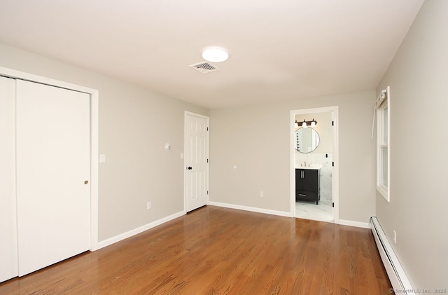 5 Great Meadow Dr, North Haven, CT 06473 - unfurnished living room featuring a baseboard radiator and wood finished floors
