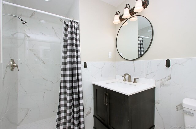 5 Great Meadow Dr, North Haven, CT 06473 - bathroom featuring tile walls, vanity, curtained shower, and a wainscoted wall