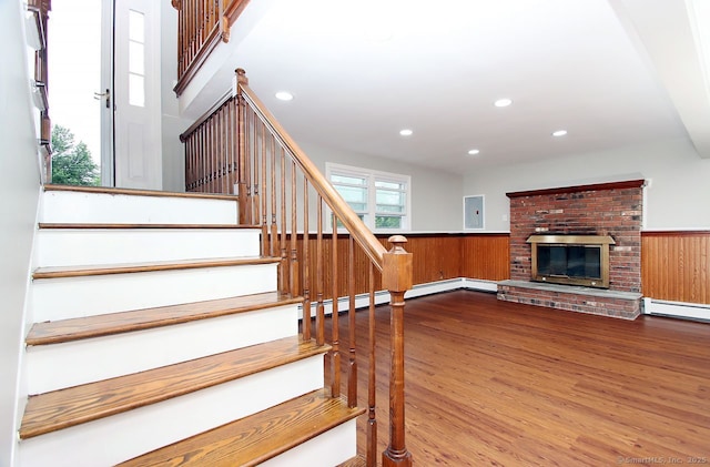 5 Great Meadow Dr, North Haven, CT 06473 - staircase featuring wood finished floors, wainscoting, recessed lighting, a brick fireplace, and wood walls