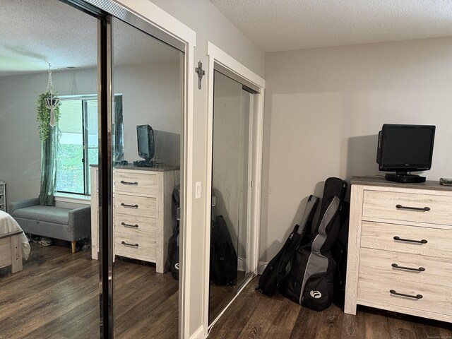 71 Aiken St Apt N7, Norwalk, CT 06851 - bedroom featuring dark wood-type flooring, multiple closets, and a textured ceiling