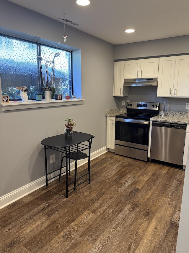 71 Aiken St Apt N7, Norwalk, CT 06851 - kitchen with stainless steel appliances, under cabinet range hood, dark wood-style flooring, recessed lighting, and light stone countertops