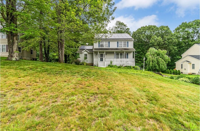 225 Michelle Ln S, Thomaston, CT 06787 - view of front of house with a porch, roof mounted solar panels, and a front lawn
