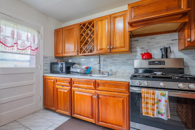 51 Park Ave Unit 2-13, Danbury, CT 06810 - kitchen with stainless steel gas stove, black microwave, light countertops, backsplash, and brown cabinetry