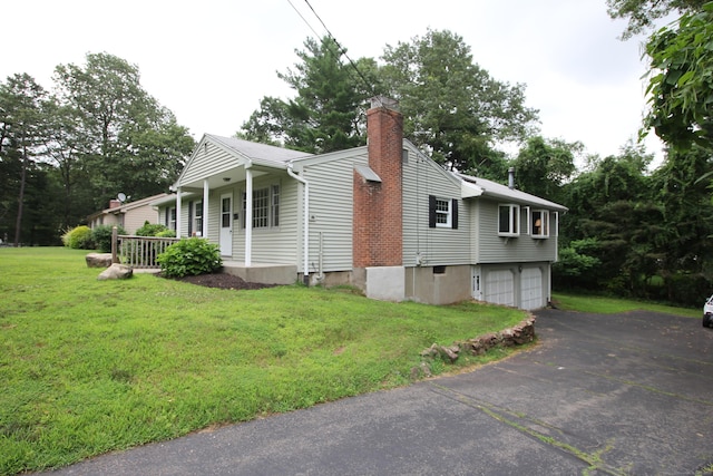 15 Birch Rd, Granby, CT 06035 - view of side of home featuring an attached garage, driveway, a chimney, a lawn, and a porch