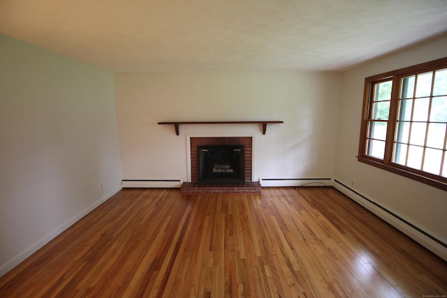 15 Birch Rd, Granby, CT 06035 - unfurnished living room with a baseboard radiator, wood finished floors, a baseboard heating unit, and a brick fireplace