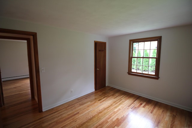 15 Birch Rd, Granby, CT 06035 - empty room featuring a baseboard radiator and light wood-type flooring