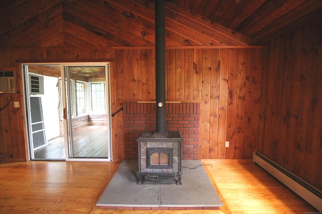 15 Birch Rd, Granby, CT 06035 - unfurnished living room with vaulted ceiling, baseboard heating, a wood stove, wood walls, and wood finished floors