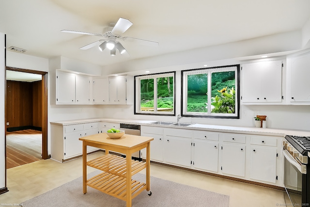 256 W Rocks Rd, Norwalk, CT 06851 - kitchen with stove, white cabinets, a ceiling fan, and light countertops
