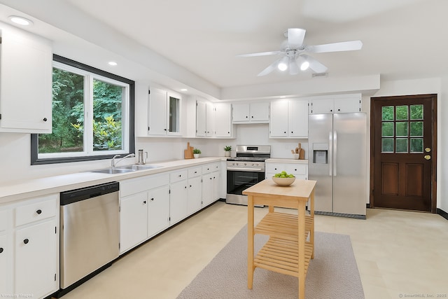 256 W Rocks Rd, Norwalk, CT 06851 - kitchen featuring appliances with stainless steel finishes, plenty of natural light, white cabinetry, light countertops, and recessed lighting