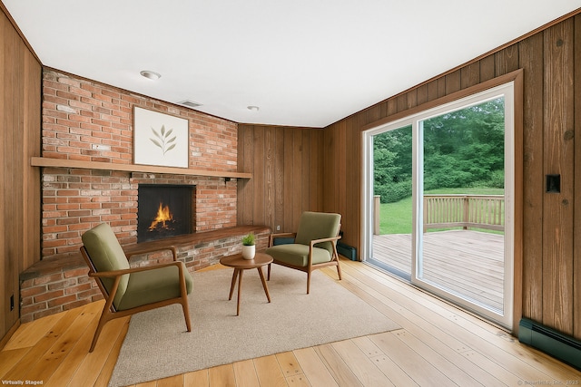 256 W Rocks Rd, Norwalk, CT 06851 - living room featuring wooden walls, a fireplace, and hardwood / wood-style flooring