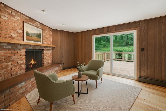 256 W Rocks Rd, Norwalk, CT 06851 - living area featuring a brick fireplace, wood walls, light wood-type flooring, and baseboard heating