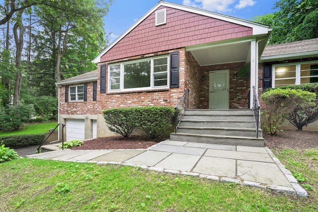 256 W Rocks Rd, Norwalk, CT 06851 - view of front facade with a garage, brick siding, and a front yard