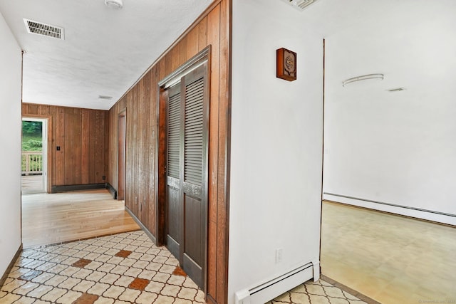 256 W Rocks Rd, Norwalk, CT 06851 - hall featuring a baseboard heating unit and wood walls