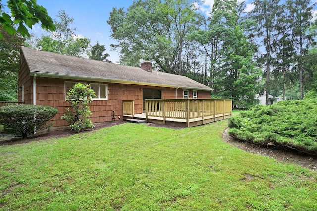 256 W Rocks Rd, Norwalk, CT 06851 - back of house with a yard, a deck, a shingled roof, and a chimney