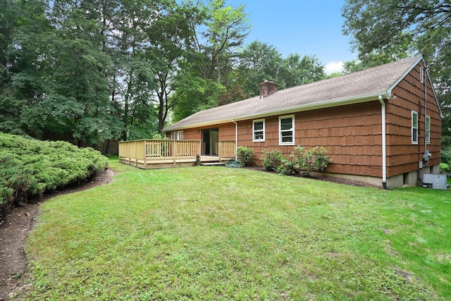 256 W Rocks Rd, Norwalk, CT 06851 - rear view of house featuring a deck, a lawn, a chimney, and roof with shingles