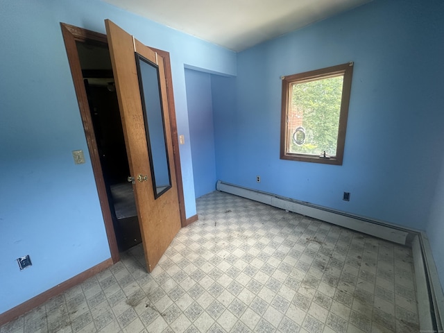117 State Ave, Killingly, CT 06241 - unfurnished bedroom with baseboard heating and light flooring