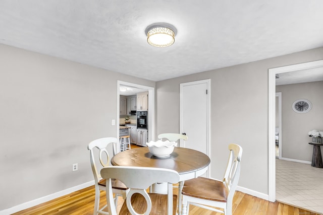 45 Neelans Rd, Enfield, CT 06082 - dining area featuring baseboards and light wood-type flooring