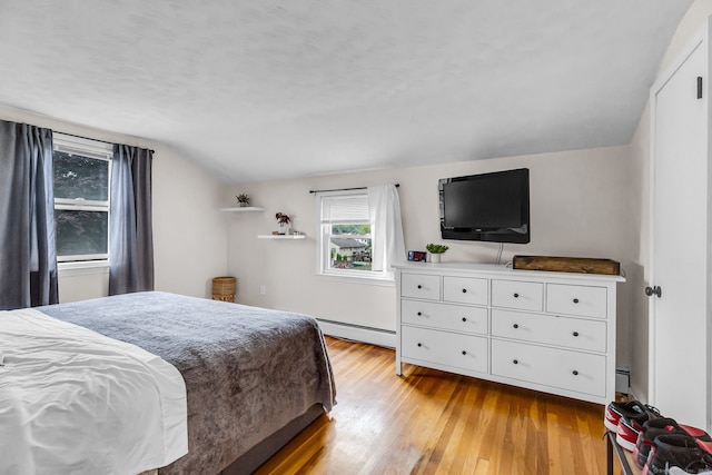 45 Neelans Rd, Enfield, CT 06082 - bedroom with a baseboard heating unit, vaulted ceiling, and light wood-style flooring