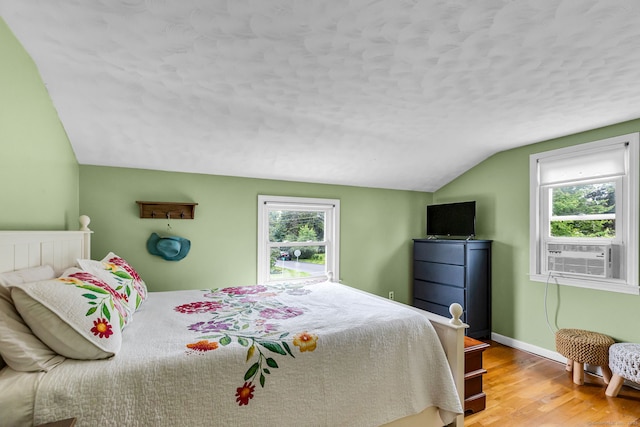 45 Neelans Rd, Enfield, CT 06082 - bedroom featuring lofted ceiling, cooling unit, wood finished floors, and a textured ceiling