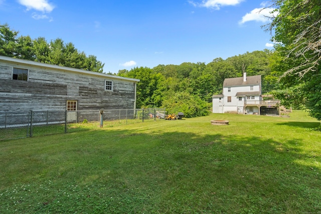 1092 Durham Rd, Guilford, CT 06437 - view of yard featuring a view of trees, a deck, and an outdoor fire pit