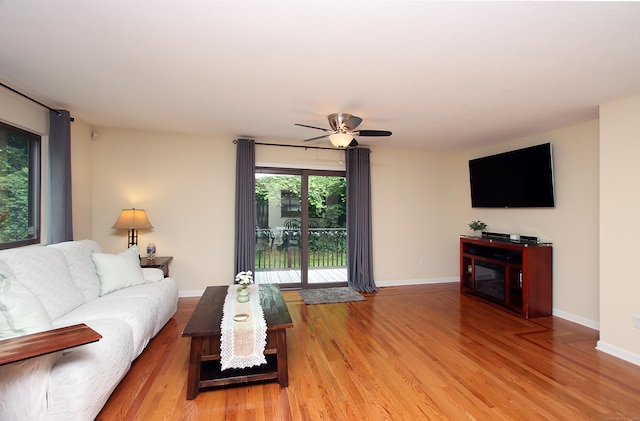 140 Thompson St Apt 16A, East Haven, CT 06513 - living room with light wood-style flooring, ceiling fan, and a fireplace