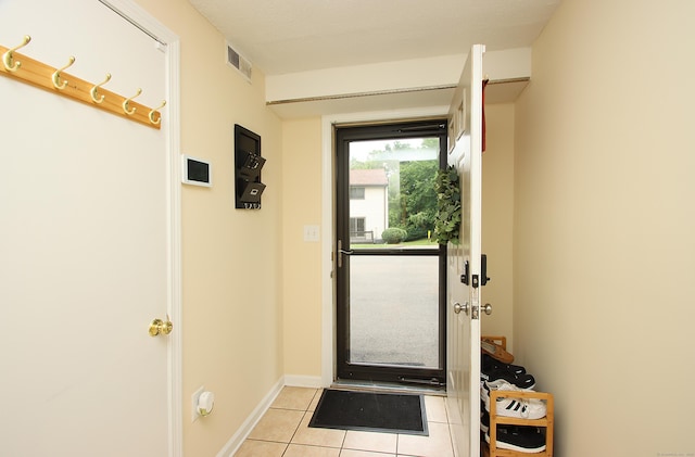 140 Thompson St Apt 16A, East Haven, CT 06513 - doorway to outside with light tile patterned floors and baseboards