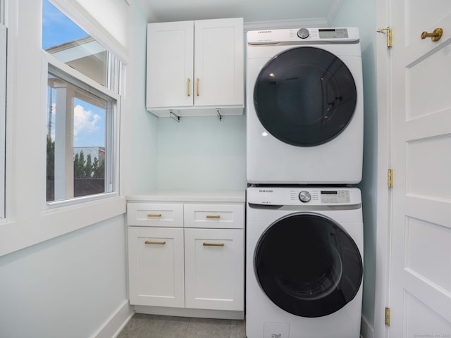 8 Platt St, Norwalk, CT 06855 - washroom with cabinet space, estacked washer and dryer, and light tile patterned floors