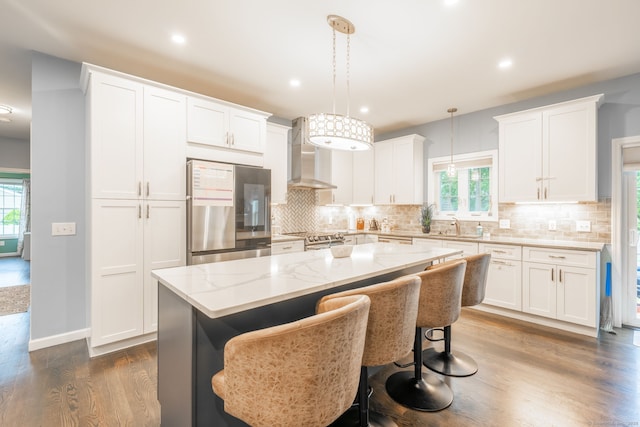 15 Contour Dr, Cheshire, CT 06410 - kitchen featuring stainless steel appliances, wall chimney range hood, dark wood-type flooring, healthy amount of natural light, and recessed lighting