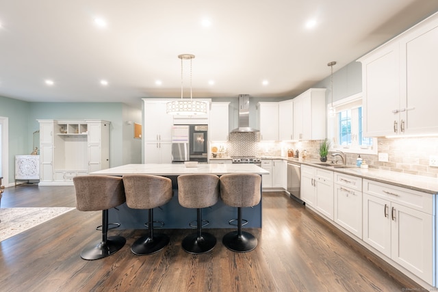 15 Contour Dr, Cheshire, CT 06410 - kitchen with wall chimney exhaust hood, appliances with stainless steel finishes, a kitchen island, dark wood-style flooring, and decorative backsplash