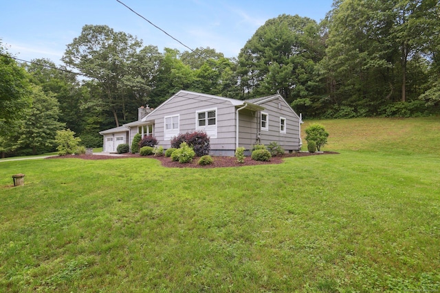 40 Chestnut Ln, Hamden, CT 06518 - view of property exterior with an attached garage, a yard, and a chimney