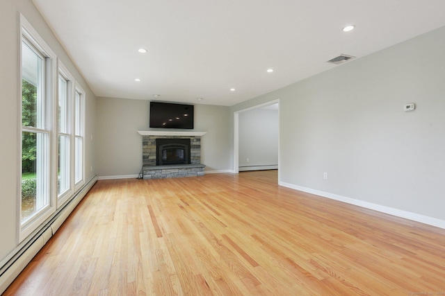 40 Chestnut Ln, Hamden, CT 06518 - unfurnished living room featuring healthy amount of natural light, a baseboard radiator, light wood-style floors, recessed lighting, and a stone fireplace
