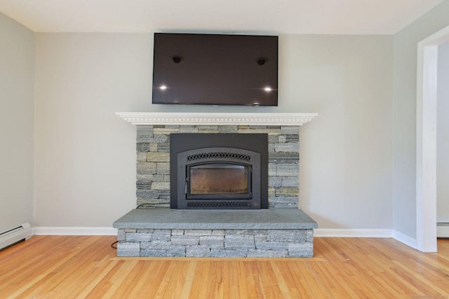 40 Chestnut Ln, Hamden, CT 06518 - detailed view of a stone fireplace, wood finished floors, and a baseboard heating unit