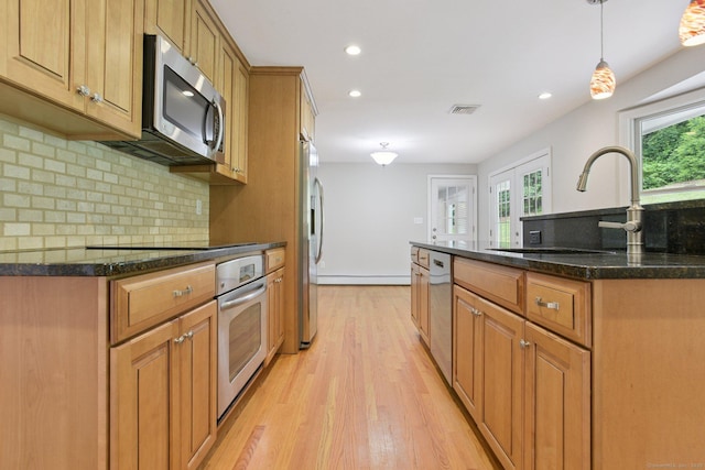 40 Chestnut Ln, Hamden, CT 06518 - kitchen featuring stainless steel appliances, brown cabinets, decorative backsplash, light wood finished floors, and recessed lighting