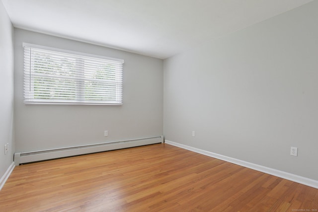 40 Chestnut Ln, Hamden, CT 06518 - spare room featuring a baseboard heating unit and light wood finished floors