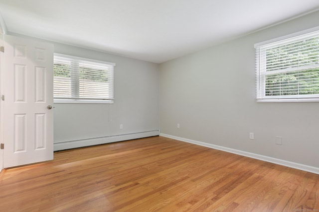 40 Chestnut Ln, Hamden, CT 06518 - spare room with a baseboard heating unit, plenty of natural light, and light wood-style flooring