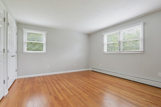 40 Chestnut Ln, Hamden, CT 06518 - unfurnished bedroom featuring multiple windows, light wood-style flooring, and baseboard heating