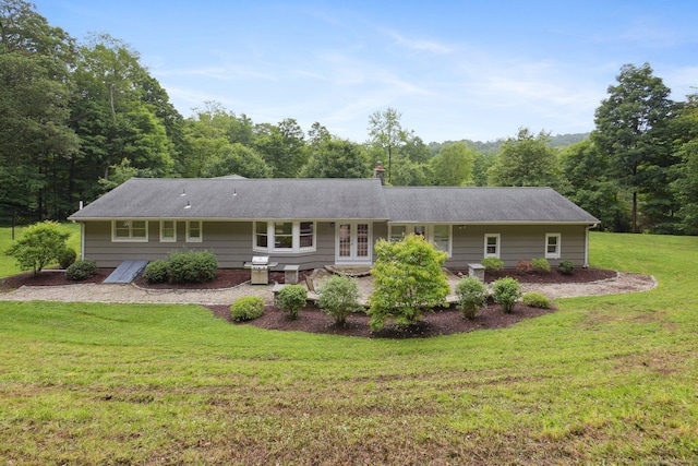 40 Chestnut Ln, Hamden, CT 06518 - view of front of house with a front yard, a patio, french doors, and a view of trees