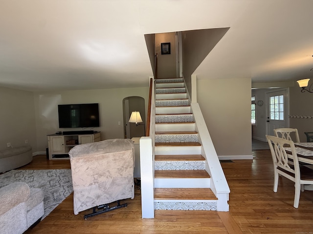 104 Wildcat Hill Rd, Harwinton, CT 06791 - staircase with arched walkways, wood finished floors, and a chandelier