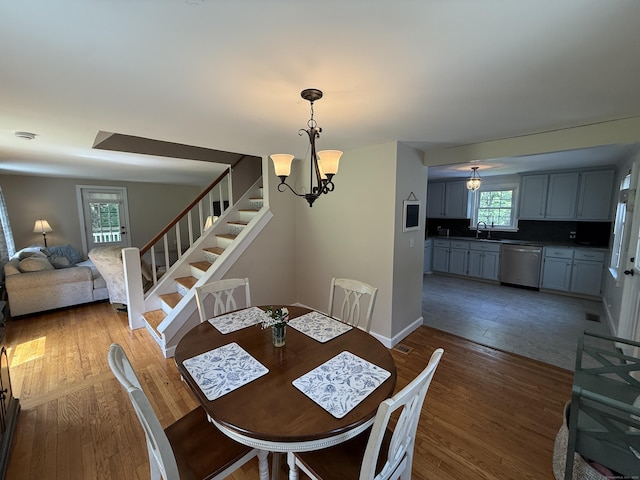 104 Wildcat Hill Rd, Harwinton, CT 06791 - dining area featuring stairs, wood finished floors, and a chandelier