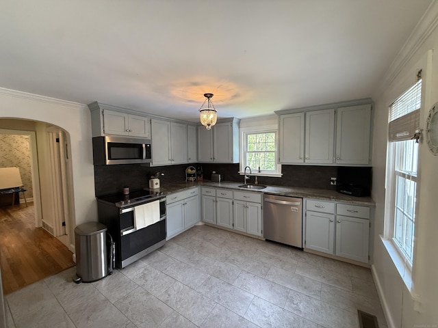 104 Wildcat Hill Rd, Harwinton, CT 06791 - kitchen featuring appliances with stainless steel finishes, backsplash, ornamental molding, arched walkways, and hanging light fixtures